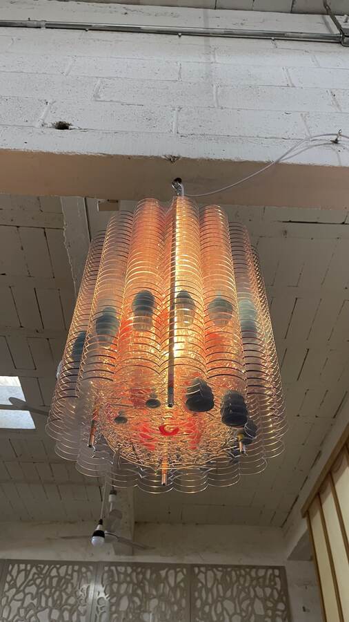 Suspended work installed at height in a lobby.