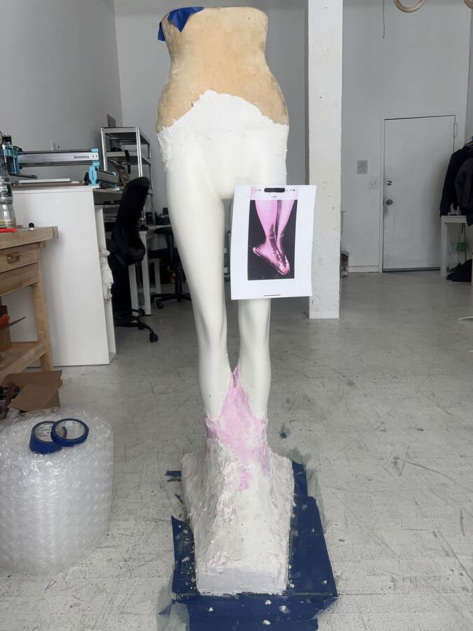 A figure in progress against its reference.